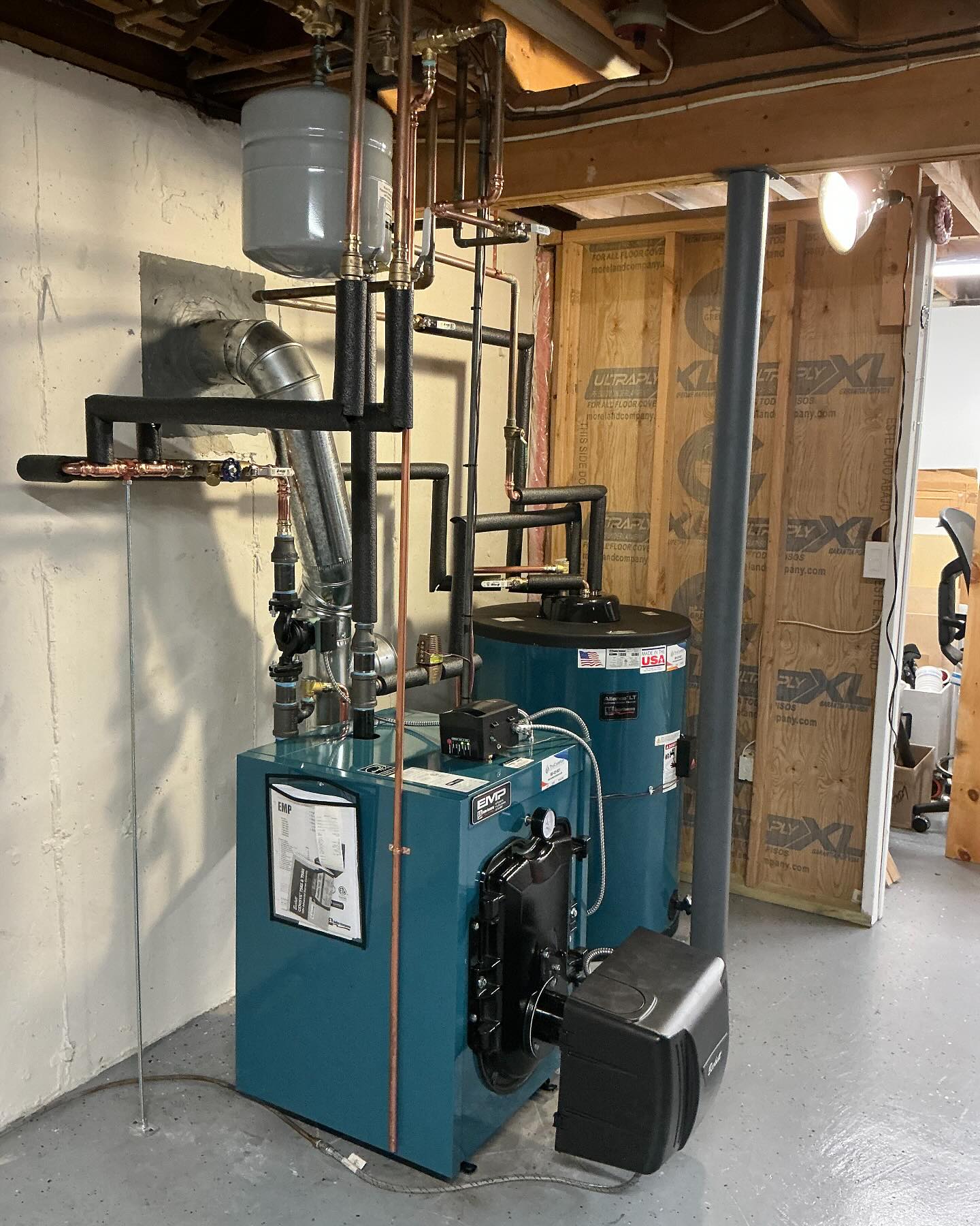 Oil boiler and indirect water heater installation in a Southington Connecticut basement with new copper piping and insulation.